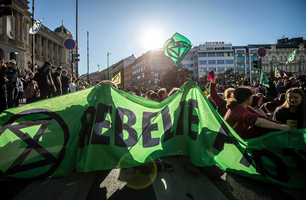Protesters block a road during an Extinction Rebellion protest on Saturday, October 12, in Prague, Czech Republic.