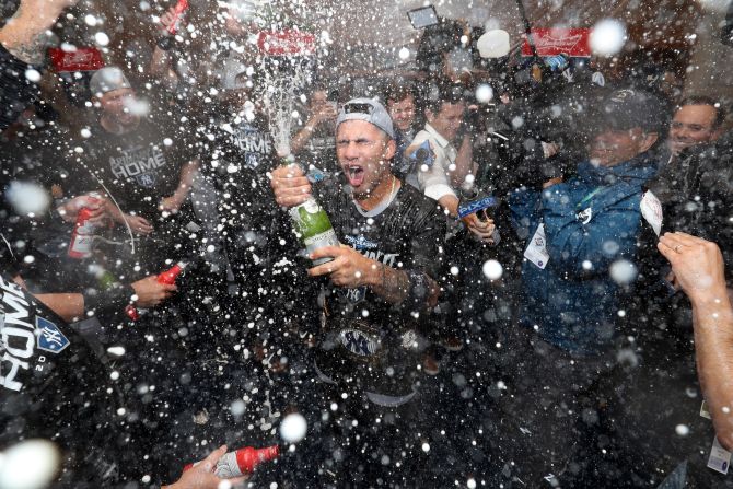 The New York Yankees spray champagne in their locker room after defeating Minnesota three games to win the American League Division Series on October 7 in Minneapolis, Minnesota.