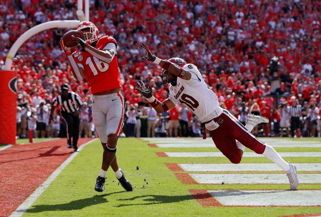 Demetris Robertson of the Georgia Bulldogs hauls in a touchdown catch over the outstretched arms of South Carolina's R.J. Roderick during the second half of their NCAA football game in Athens, Georgia, on October 12. Georgia was ultimately upset by the Gamecocks, losing in overtime.