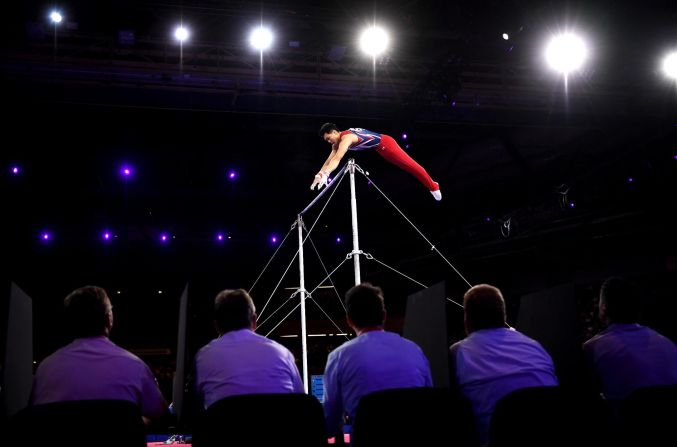 Judges watch Chia-Hung Tang of Taipei compete in the horizontal bar final of the Gymnastics World Championships in Stuttgart, Germany, on October 13.