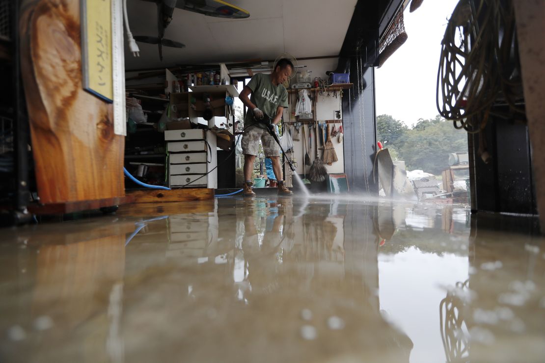 A volunteer helps clean up Monday, October 14, 2019, in Kawagoe City, Japan. 