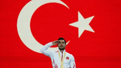 Ibrahim Colak makes a military salute during the national anthem.