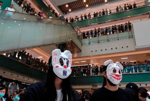 Protesters wearing masks in defiance of <a href=