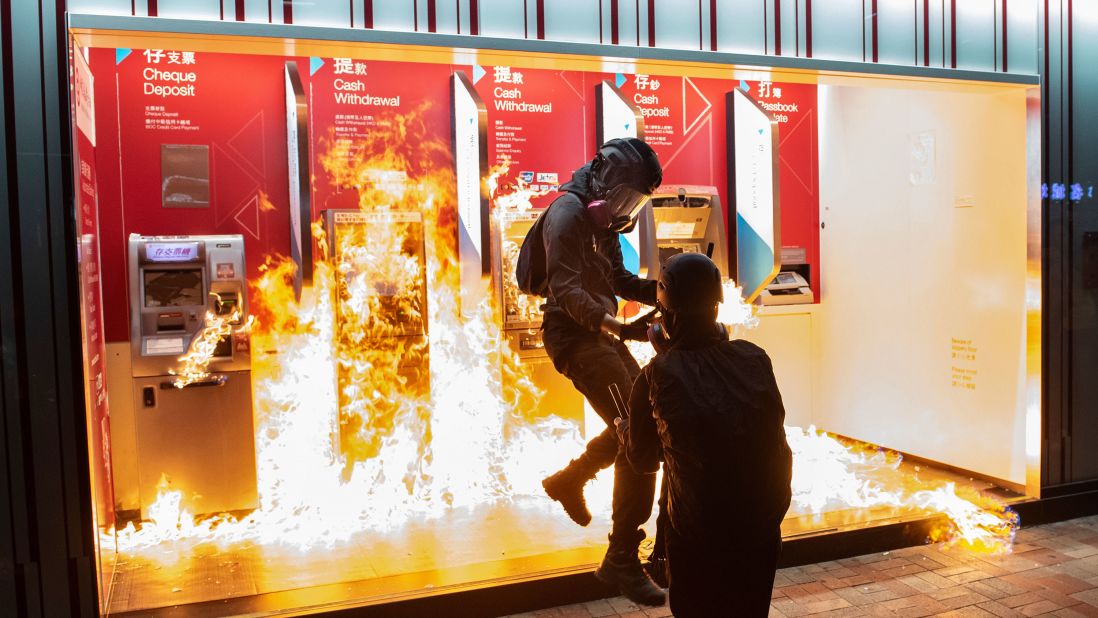 Protesters set fire to a Bank of China branch on Sunday, October 13. It was the 19th consecutive weekend of anti-government protests in Hong Kong.