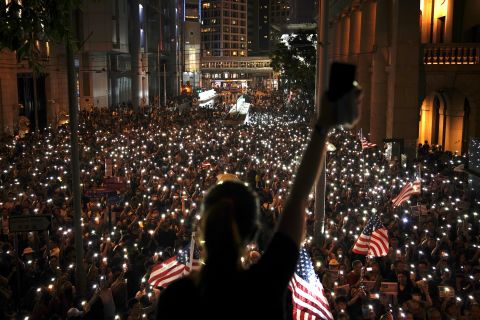 Protesters use the lights on their phones during a rally in central Hong Kong's business district.