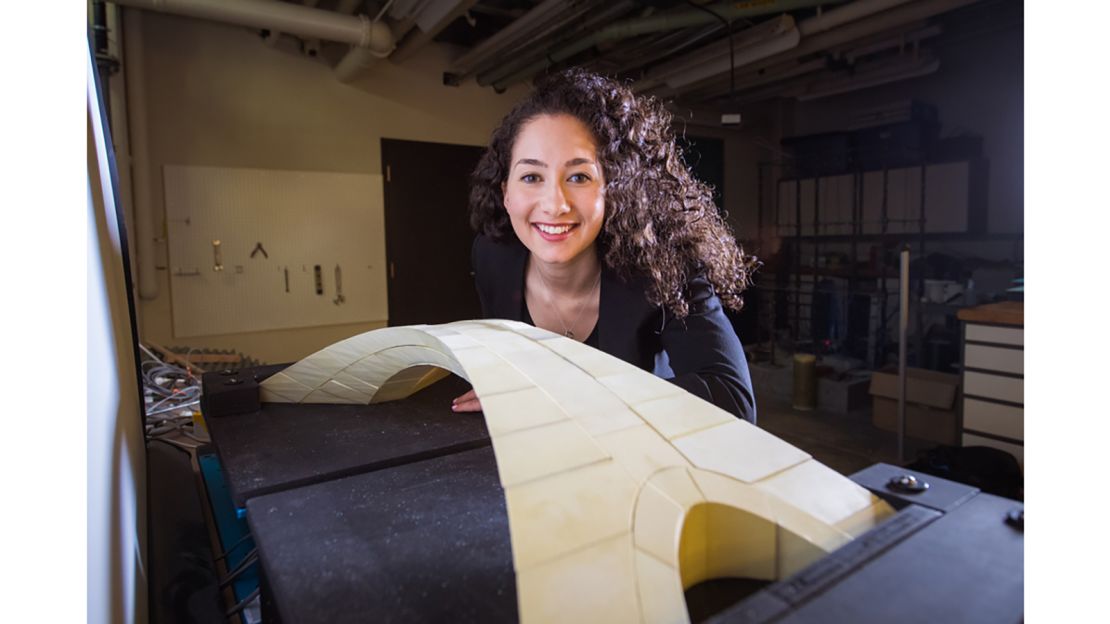 Karly Bast, a recent MIT graduate student, with the scale model she created.