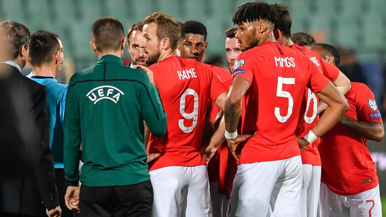 England players speak with the referees during the interruption of the clash against Bulgaria.