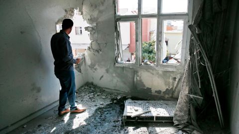 A person inspects the damage from a mortar fired from inside Syria, in Akcakale, southeastern Turkey, on Sunday.