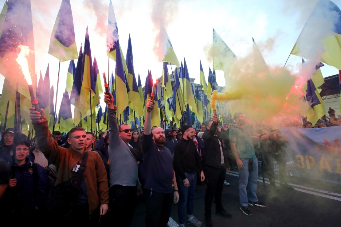  Demonstrators light smoke flares as they march in central Kiev.