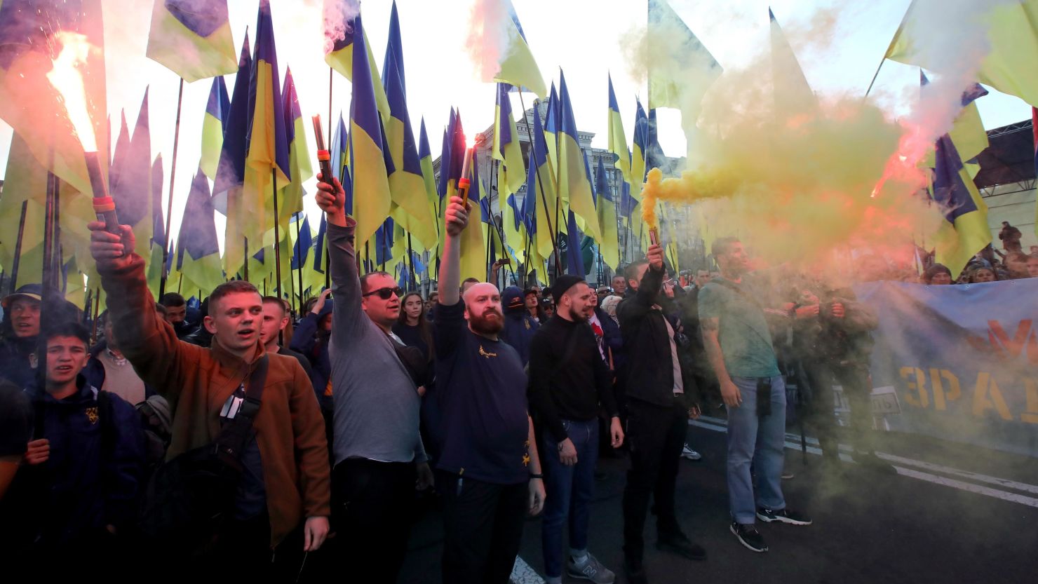 Demonstrators light smoke flares as they march in central Kiev.