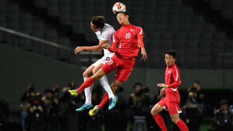 An Byong Jun of North Korea and Kim Shinwook of South Korea compete for the ball during the EAFF E-1 Men's Football Championship between North Korea and South Korea at Ajinomoto Stadium on December 12, 2017 in Chofu, Tokyo, Japan.