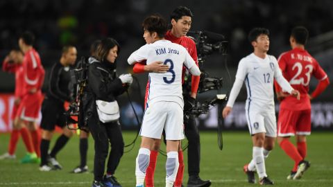 Kim Jinsu of South Korea and Ri Yong Jik of North Korea embrace after the EAFF E-1 Men's Football Championship between North Korea and South Korea at Ajinomoto Stadium on December 12, 2017 in Chofu, Tokyo, Japan.