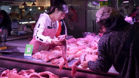 A vendor sells pork at a market in Beijing on October 15, 2019. China's consumer inflation accelerated at its fastest pace in almost six years in September as African swine fever sent pork prices soaring nearly 70 percent, official data showed on October 15.