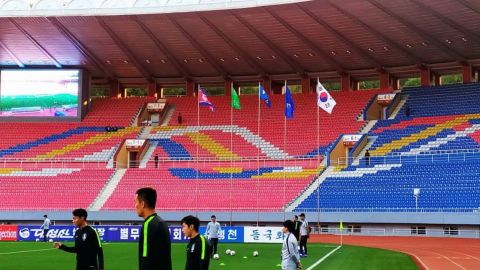Players warm up before the match begins on October 15, 2019, at the Kim Il Sung Stadium in Pyongyang, North Korea.
