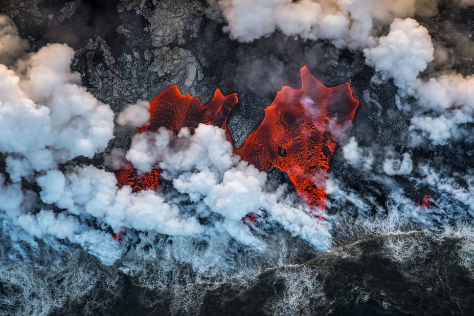 <strong>Earth's Environments. </strong>Lava flows into the Pacific Ocean following an eruption of Kîlauea, an active volanco on Hawaii's Big Island. This aerial image was taken by Luis Vilariño Lopez.