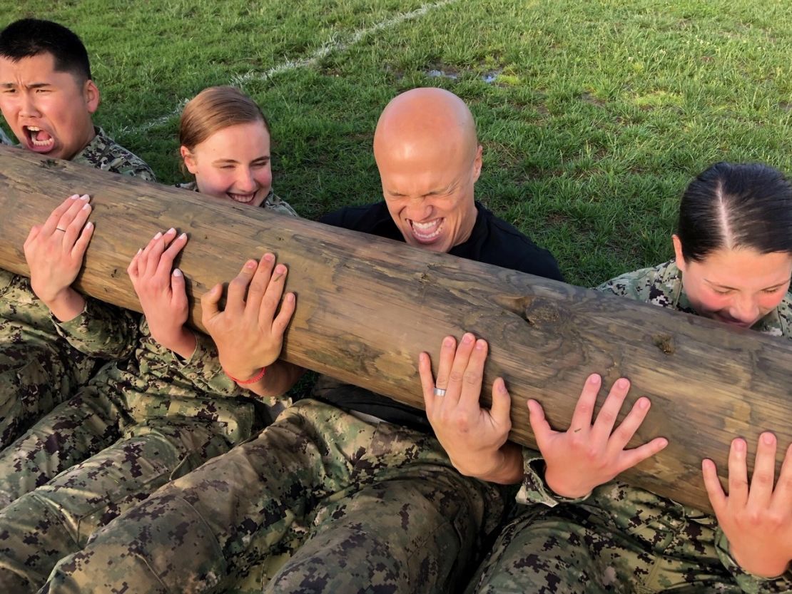 CNN Sports anchor Coy Wire with plebes lifting logs during Sea Trials.