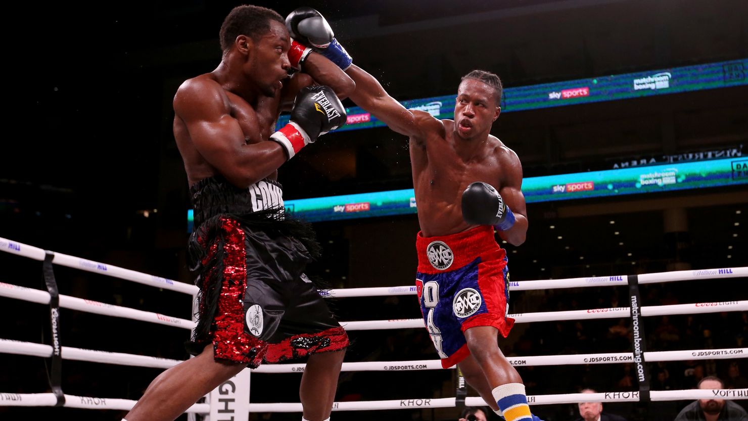 Patrick Day (R) lands a punch on Charles Conwell in the third round of their super-welterweight fight.