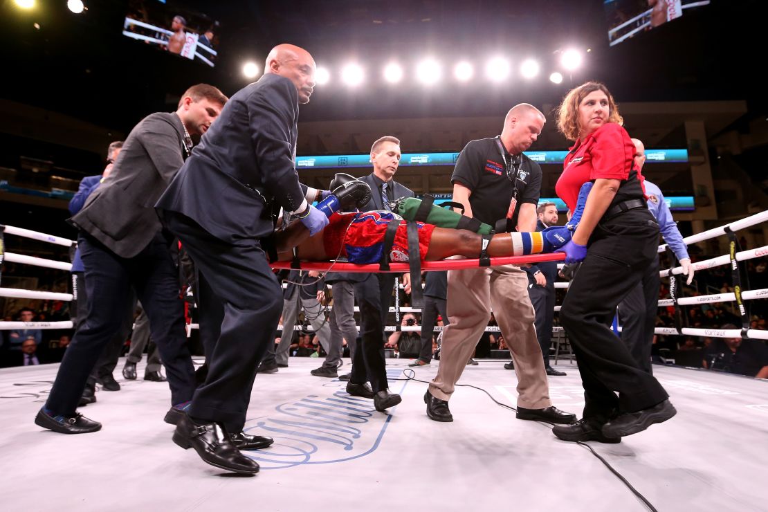 Day is stretchered out of the ring after being knocked out by Conwell.