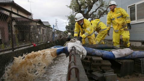 Firefighters pump water from a flooded area in the aftermath of Typhoon Hagibis in Nagano on October 15, 2019.
