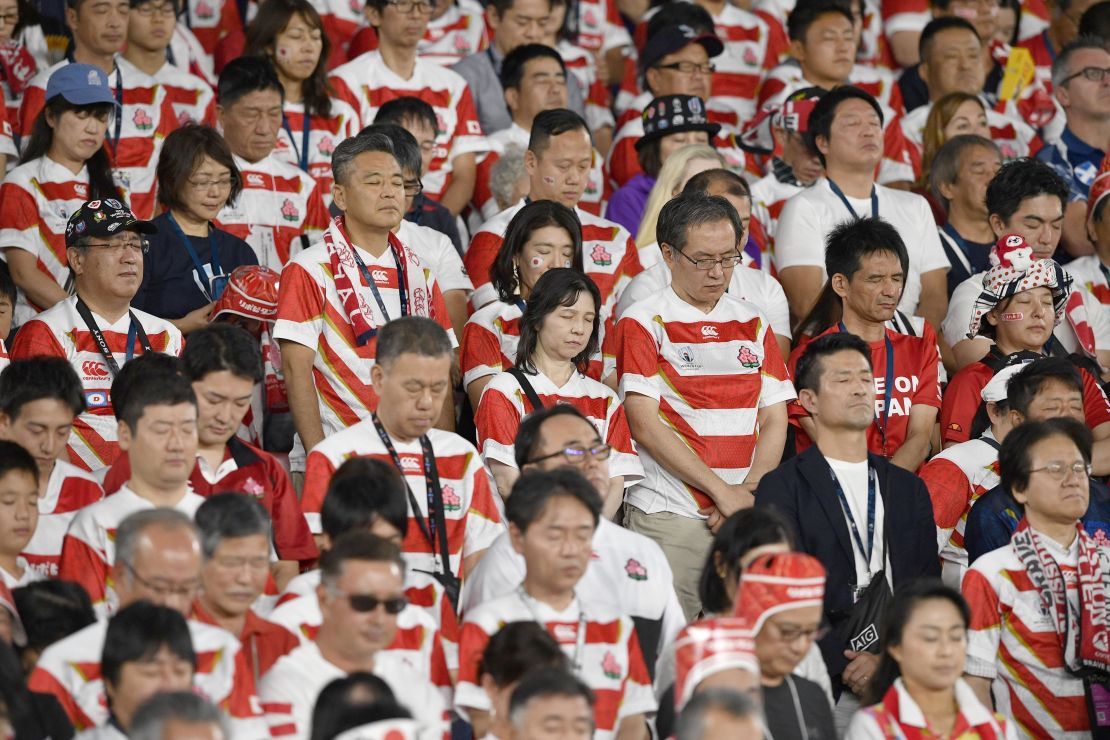 Spectators observe a moment of silence ahead the match between Japan and Scotland in memory of the victims of Typhoon Hagibis that ripped through wide areas of Japan the previous day. 