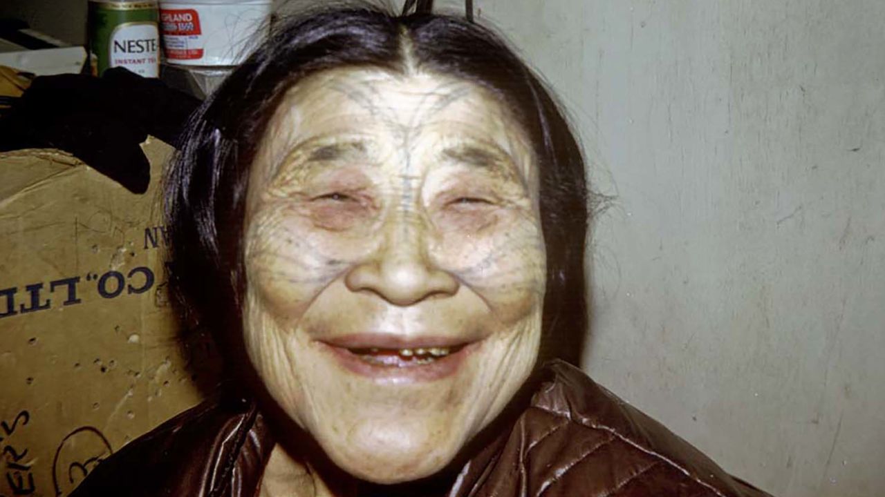 An Inuit woman with traditional tattoos on her face smiles in this 1969 archival photo from Canada's north.