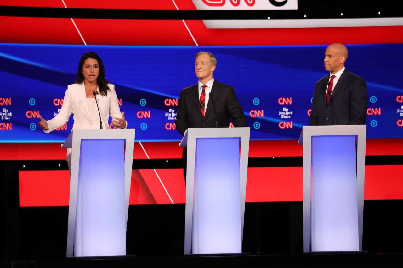 Gabbard answers a question next to Steyer and Booker. Gabbard was absent from last month's debate because she didn't have the numbers to qualify.