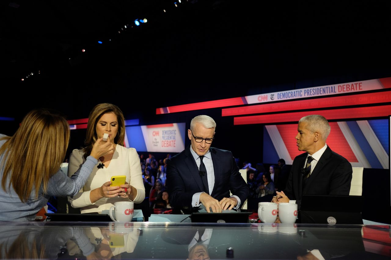 The debate's moderators during a commercial break. From left are CNN's Erin Burnett, CNN's Anderson Cooper and New York Times national editor Marc Lacey.