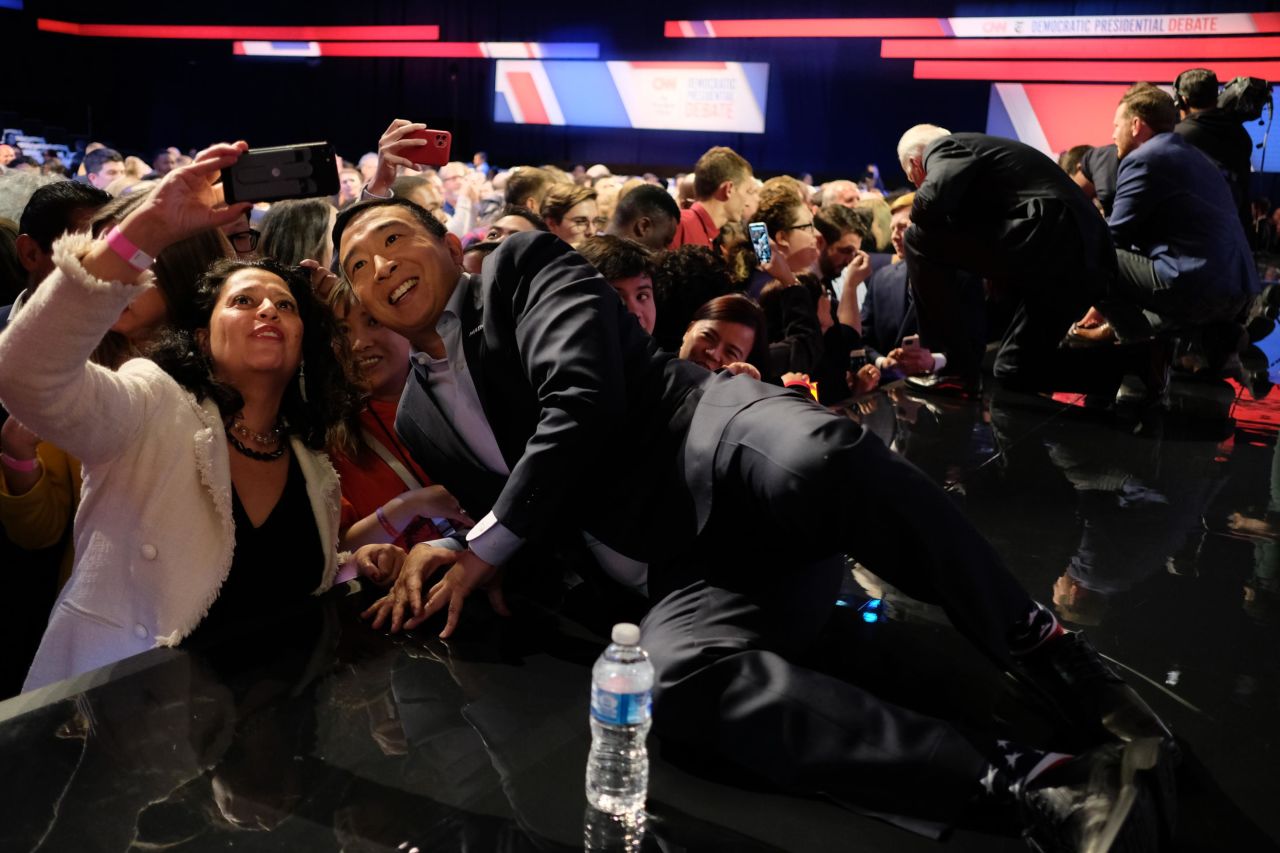 Yang takes a selfie with an audience member after the debate.