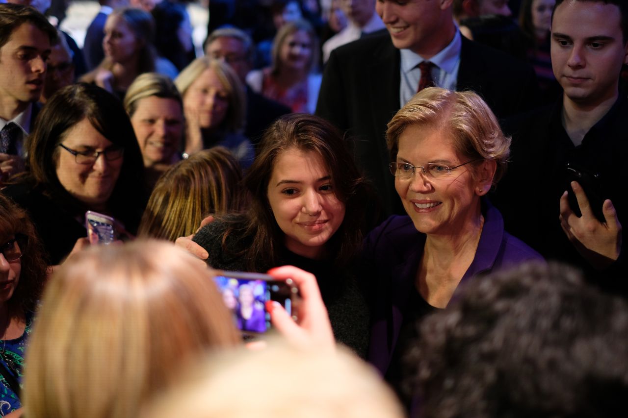 Warren poses for a photo after the debate.