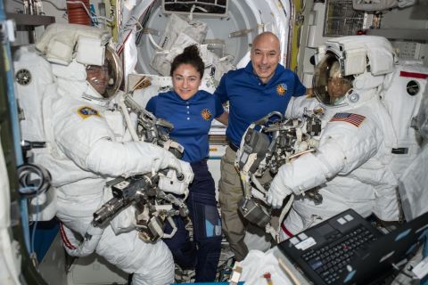 NASA astronauts Andrew Morgan (left) and Christina Koch (right) are suited up in US spacesuits, assisted by NASA Flight Engineer Jessica Meir and European Space Agency Commander Luca Parmitano.