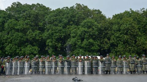 Members of the Mexican National Guard stand with their shields in case of a confrontation during the migrant caravan near Tuzantan, Chiapas state, Mexico, Saturday, Oct. 12, 2019. Hundreds of migrants were arrested by Mexican authorities as they made their way to Mexico City.