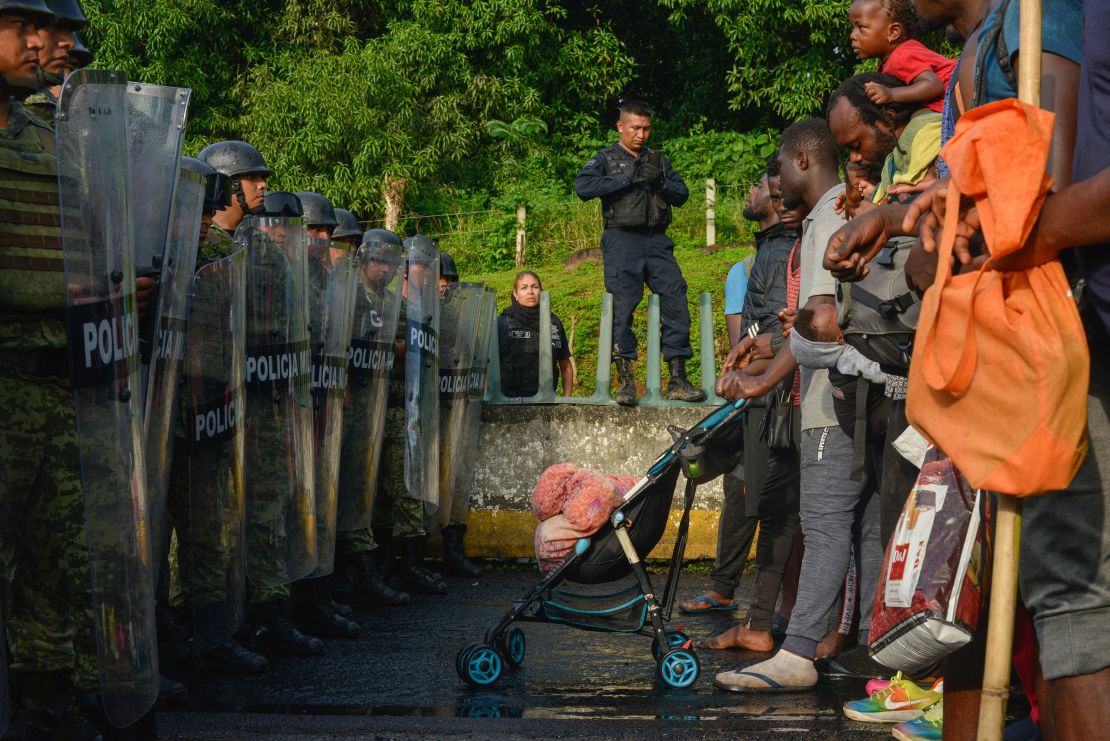 Members of Mexico's National Guard block a large group of migrants near Tuzantan, Mexico, on October 12. 