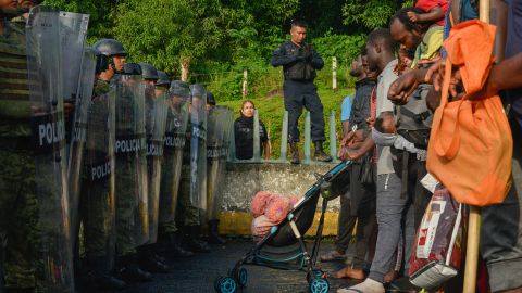 Members of Mexico's National Guard block a large group of migrants near Tuzantan, Mexico, on October 12.