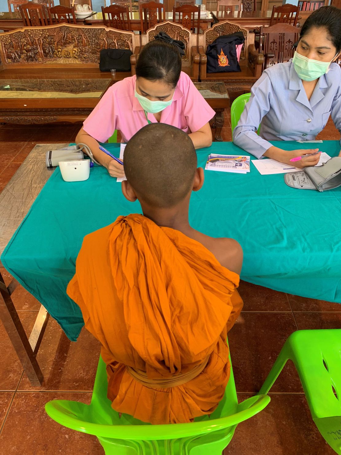 A young monk gets his health checked.