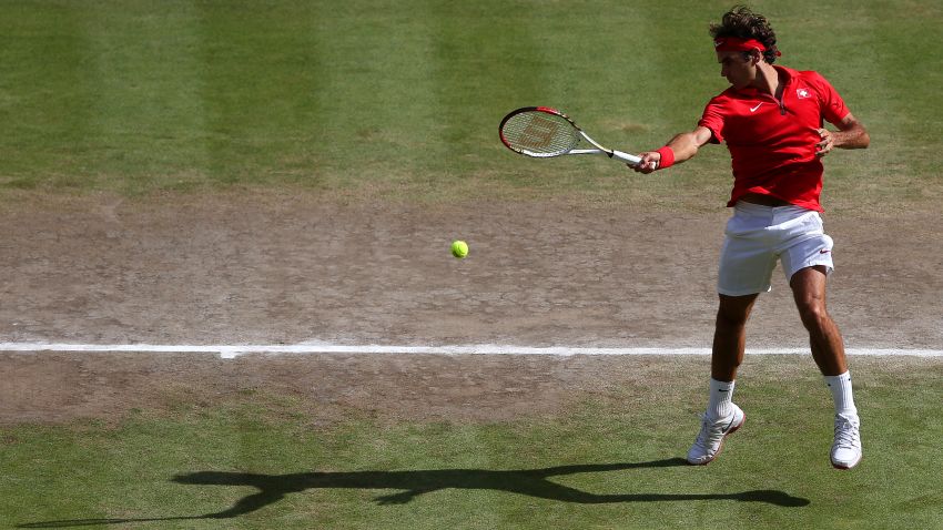 LONDON, ENGLAND - AUGUST 05: Roger Federer of Switzerland returns a shot against Andy Murray of Great Britain during the Men's Singles Tennis Gold Medal Match on Day 9 of the London 2012 Olympic Games at the All England Lawn Tennis and Croquet Club on August 5, 2012 in London, England. (Photo by Julian Finney/Getty Images)