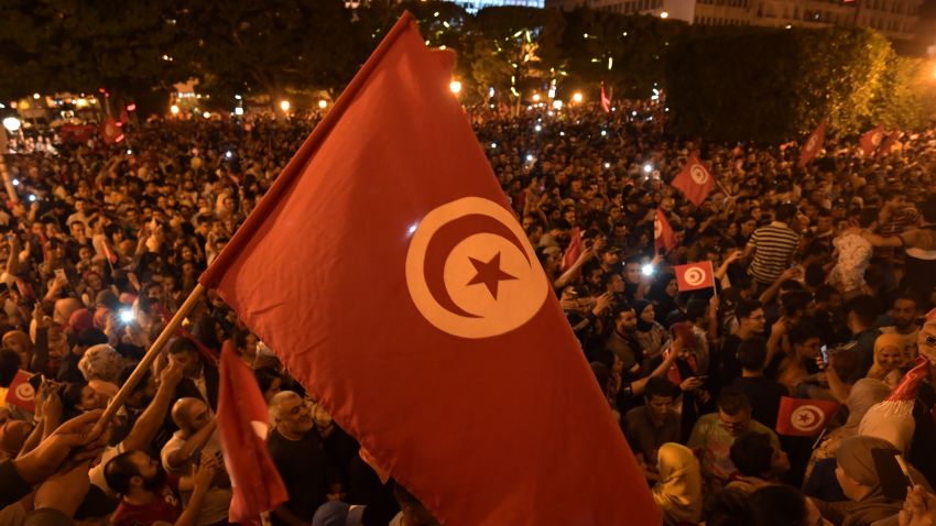 Tunisians gather to celebrate the victory of Kais Saied in the Tunisia's presidential runoff on October 13, 2019, in the capital Tunis. - Conservative academic Kais Saied, a political outsider, won a landslide victory Sunday in Tunisia's presidential runoff, sweeping aside his rival, media magnate Nabil Karoui, state television said. (Photo by Fethi Belaid / AFP) (Photo by FETHI BELAID/AFP via Getty Images)