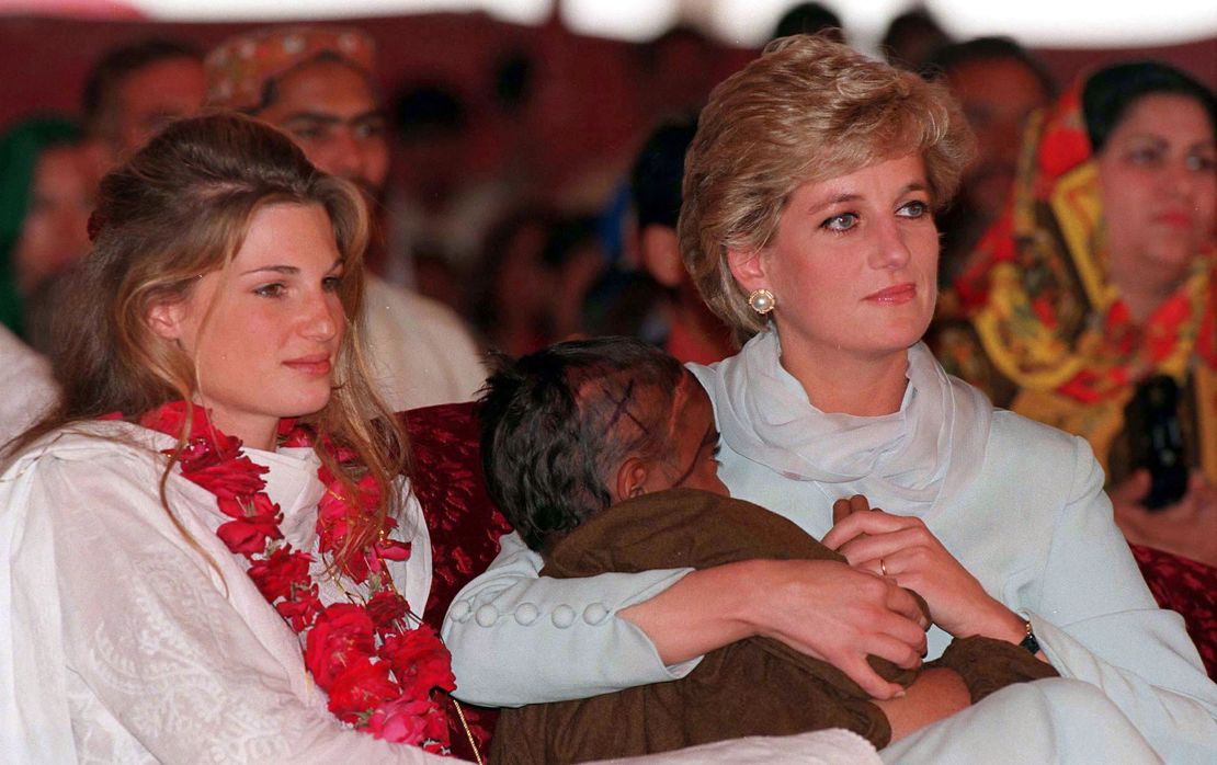 Diana, Princess of Wales, cradles a sick child in her arms while she sits with Jemima Khan during her visit to Imran Khan's cancer hospital in Lahore, Pakistan in 1996. 