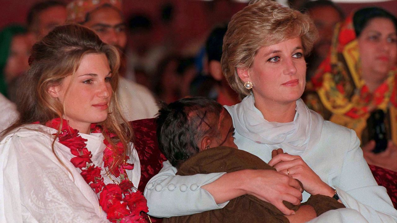 Diana, Princess of Wales, cradles a sick child in her arms while she sits with Jemima Khan during her visit to Imran Khan's cancer hospital in Lahore, Pakistan in 1996.