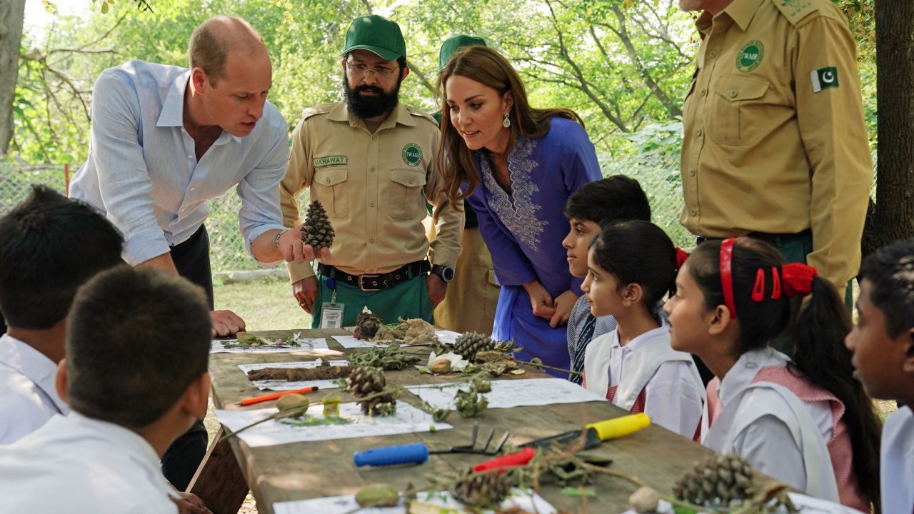 The royal couple talk with local school children in the Margallah Hills on the second day of the royal visit to Pakistan on Tuesday in Islamabad, Pakistan.