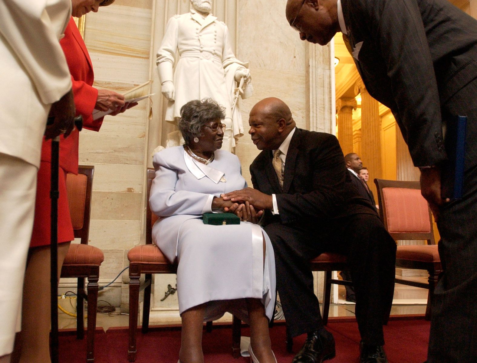 Viola Pearson, the widow of Levi Pearson, talks with Cummings after a ceremony honoring her husband with the Congressional Gold Medal in September 2004. Levi Pearson was among four people honored for their involvement in Briggs v. Elliott, a court case that challenged segregation in South Carolina schools.