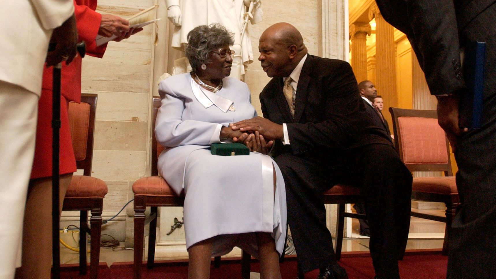 Viola Pearson, the widow of Levi Pearson, talks with Cummings after a ceremony honoring her husband with the Congressional Gold Medal in September 2004. Levi Pearson was among four people honored for their involvement in Briggs v. Elliott, a court case that challenged segregation in South Carolina schools.
