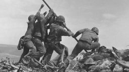 U.S. Marines of the 28th Regiment, 5th Division, raise the American flag atop Mt. Suribachi, Iwo Jima, on Feb. 23, 1945. Strategically located only 660 miles from Tokyo, the Pacific island became the site of one of the bloodiest, most famous battles of World War II against Japan.  (AP Photo/Joe Rosenthal)