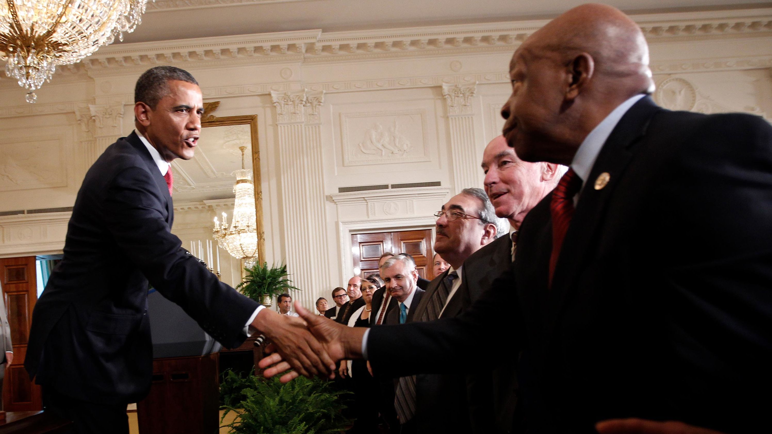 President Barack Obama shakes hands with Cummings after signing HR 4348, the Surface Transportation Bill, during a ceremony at the White House in July 2012. 