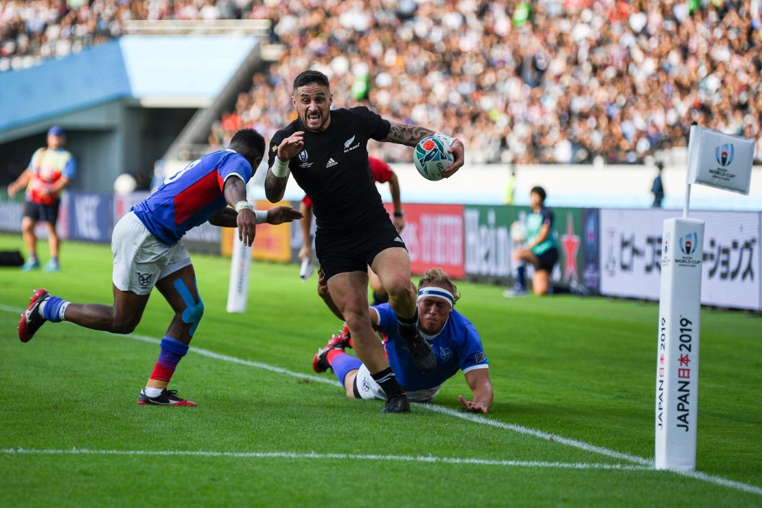 New Zealand's scrum-half TJ Perenara runs in to score a try against Namibia.
