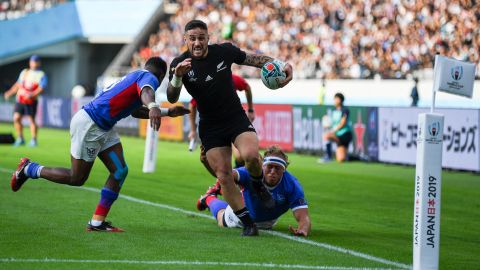New Zealand's scrum-half TJ Perenara runs in to score a try against Namibia.
