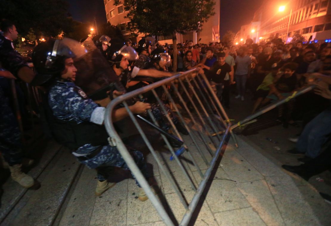 Demonstrators clash with police on October 17, 2019 outside the government palace in Beirut. 