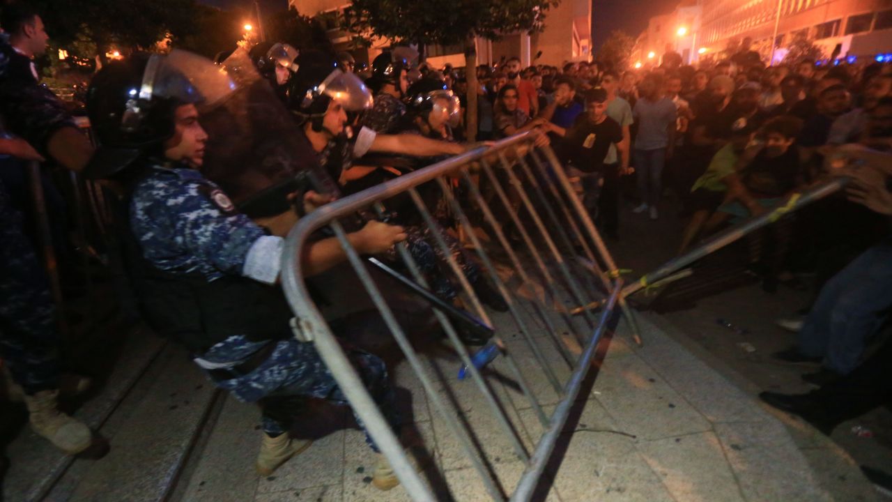 Demonstrators clash with police on October 17, 2019 outside the government palace in Beirut.