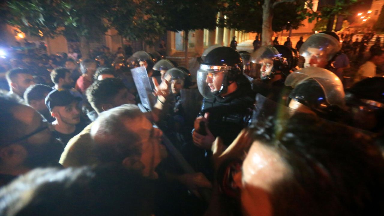 Demonstrators clash with police outside the government palace in Beirut. 