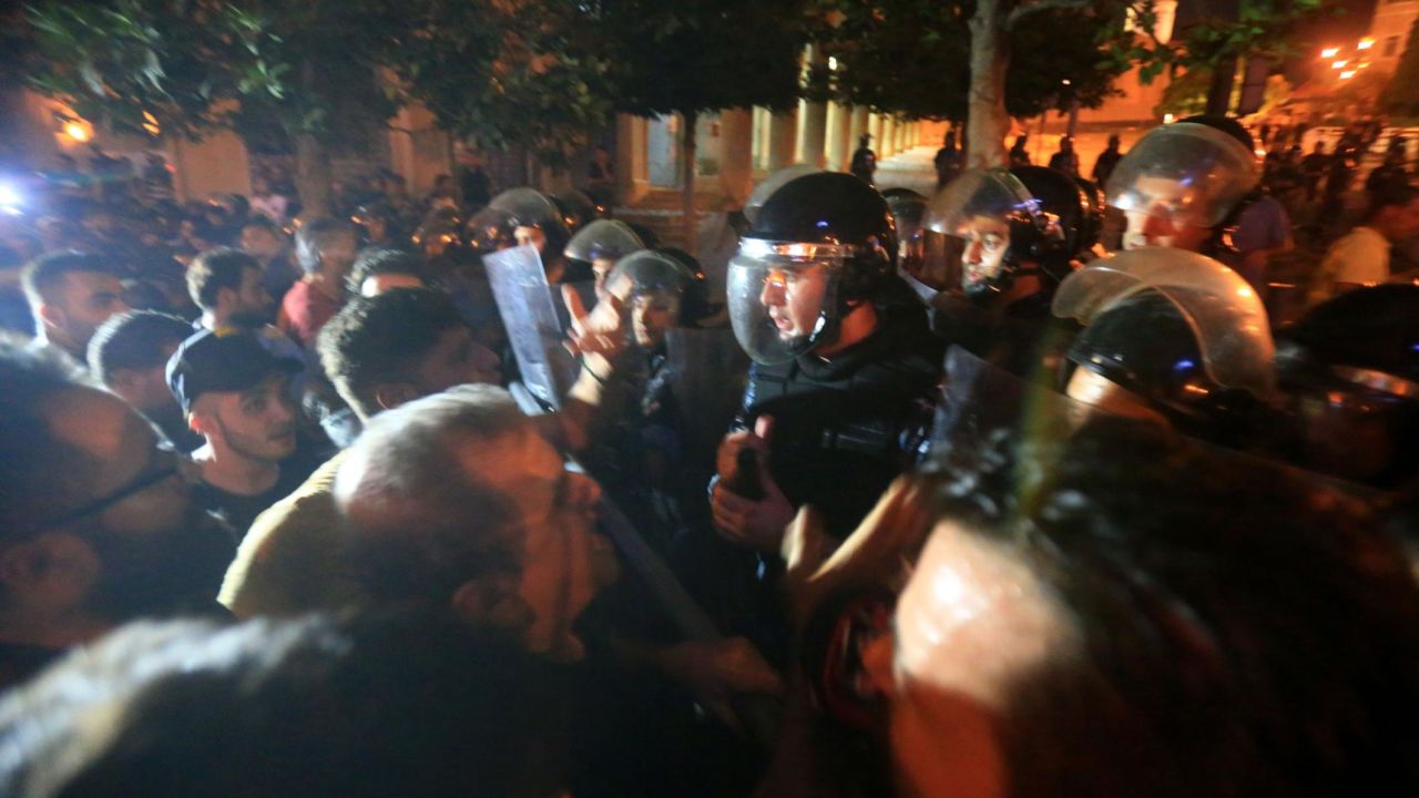 Demonstrators clash with police outside the government palace in Beirut.