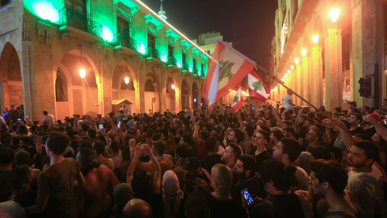 Demonstrators wave flags outside the government palace in Beirut.